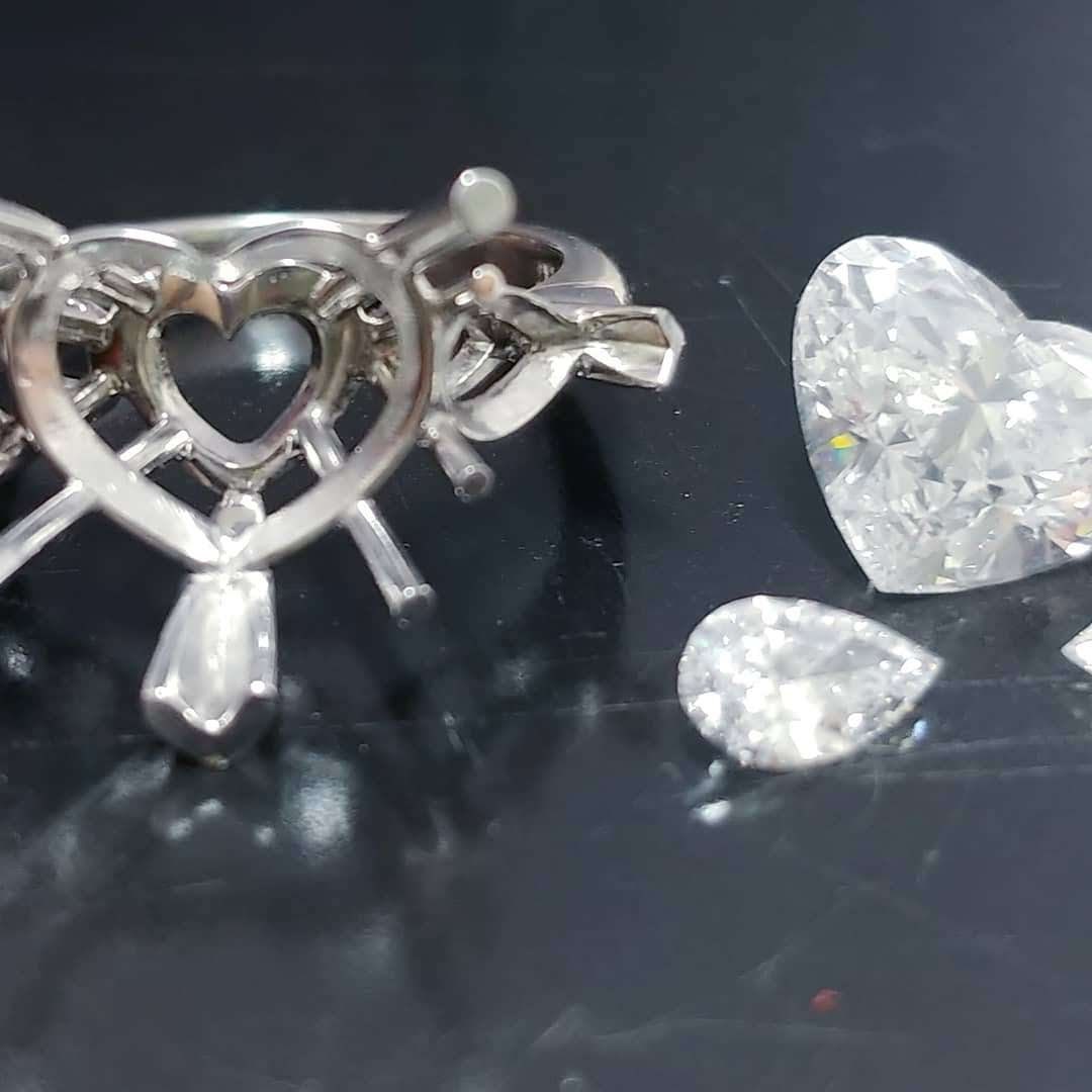 Platinum handmade ring with heart shaped diamond center