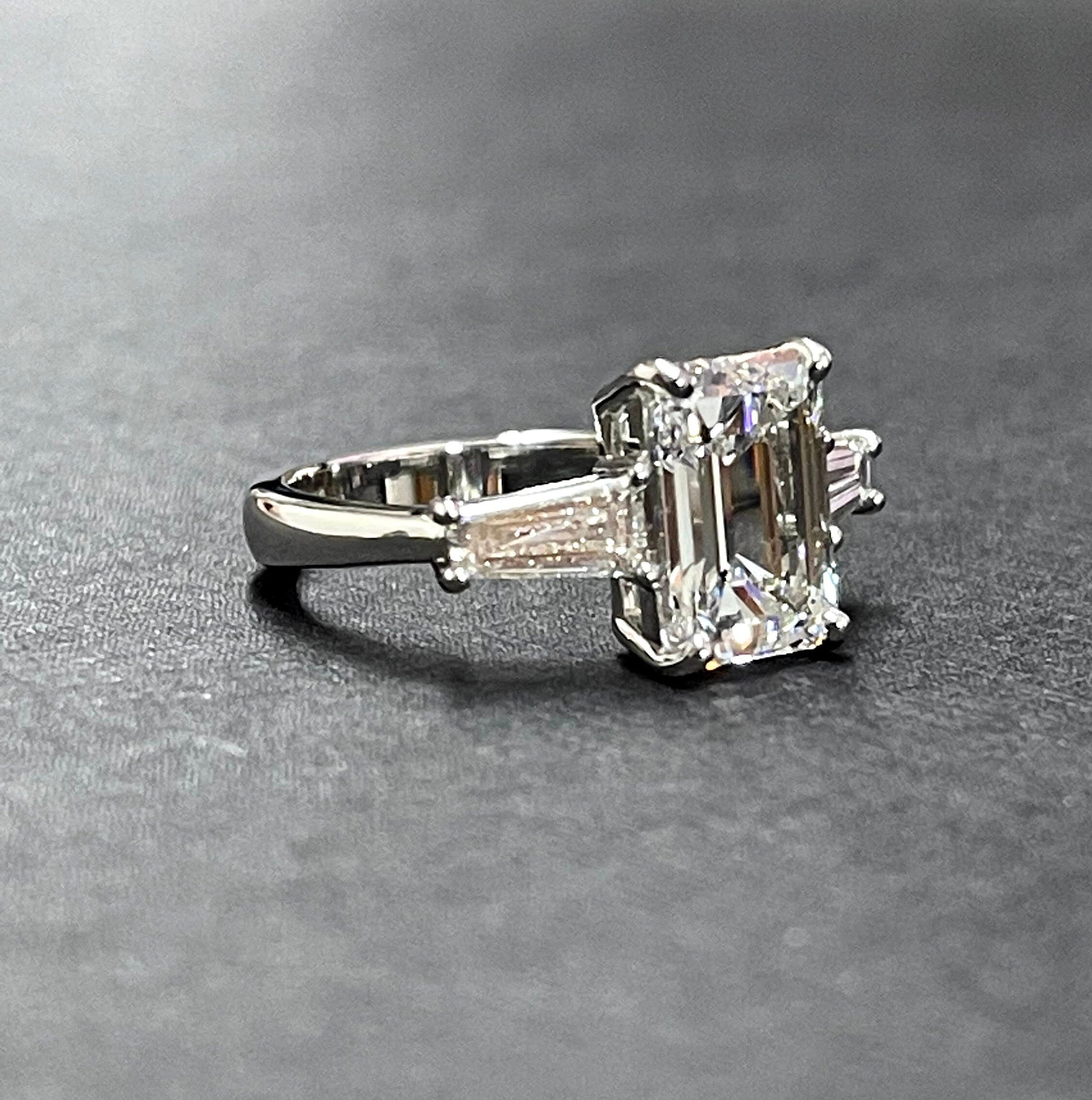 Platinum diamond center baguette sides ring