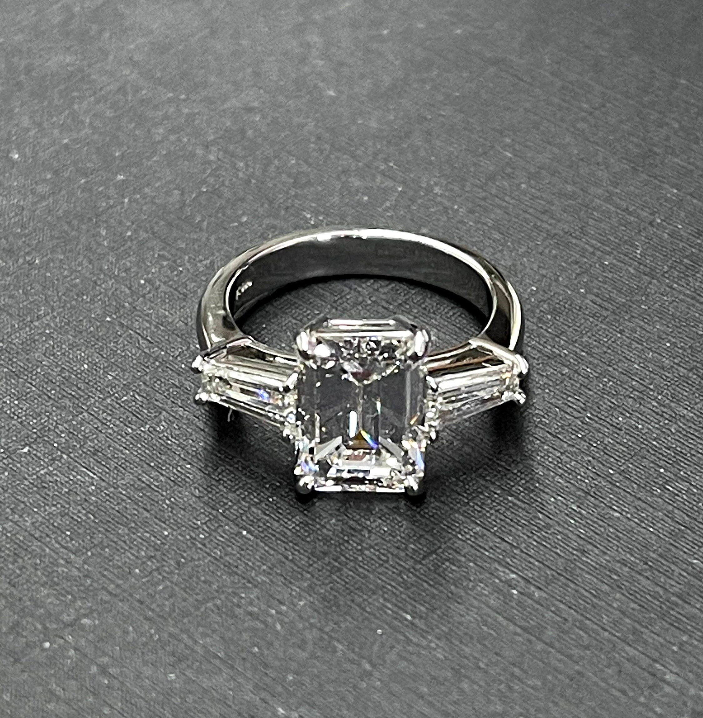 Platinum diamond center baguette sides ring